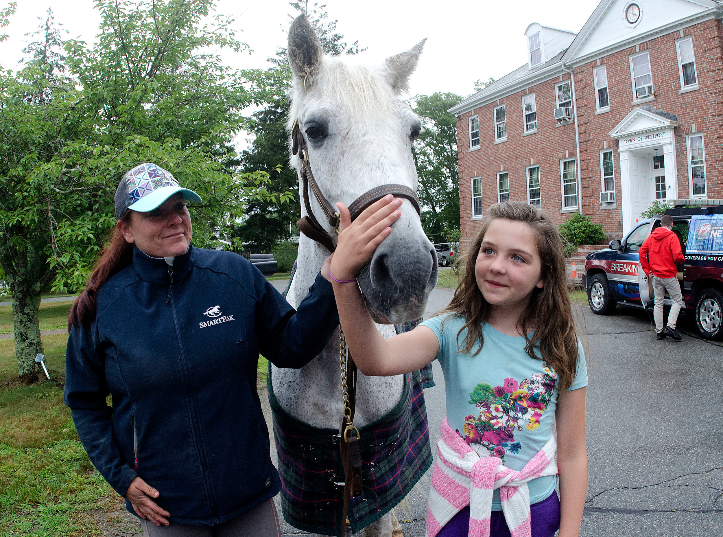 Deb Devlin of Don't Forget us Pet Us in Dartmouth (left) and Izabella Appleyard, 10, with Olaf, a horse that was once held at the tenant ‘farm’ at Monday’s ceremony.