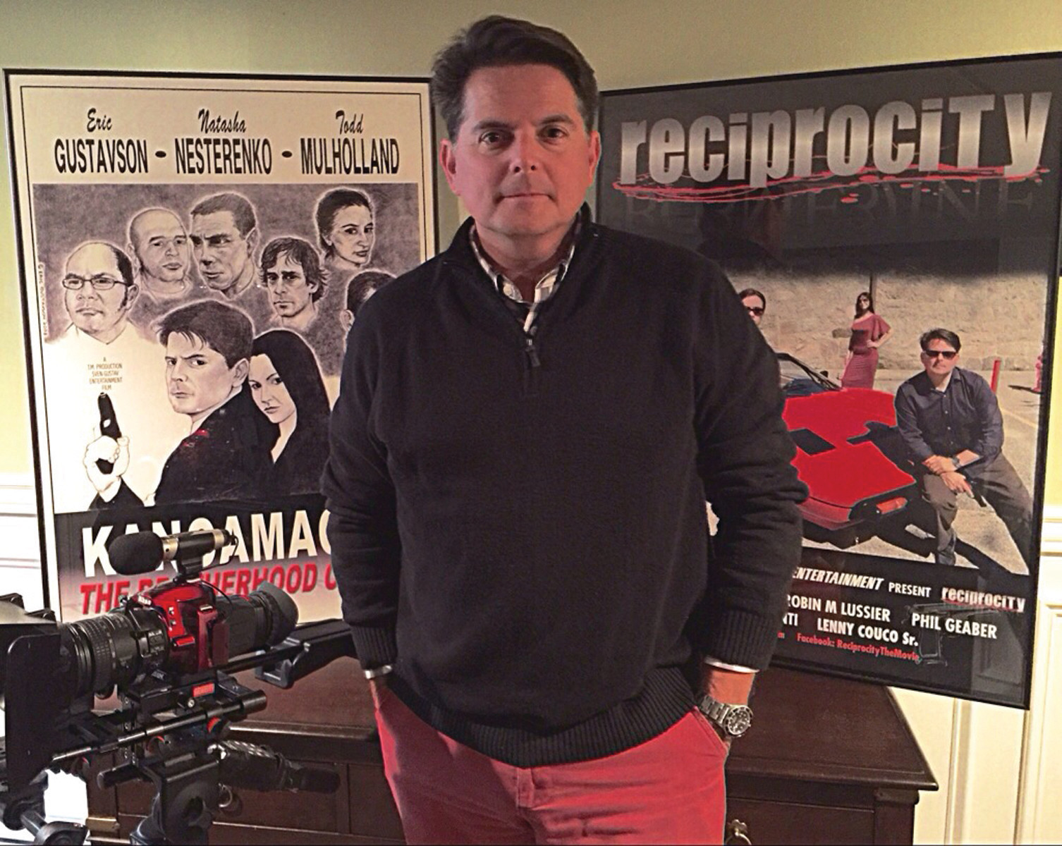 GRASSROOTS FILMMAKER: Todd Mulholland has been following his passion, making movies, for 20 years. Seen here with his camera, and flanked by the movie posters from his last two movies, Mulholland and his family are looking ahead to the filming of his next movie, a suspense thriller.