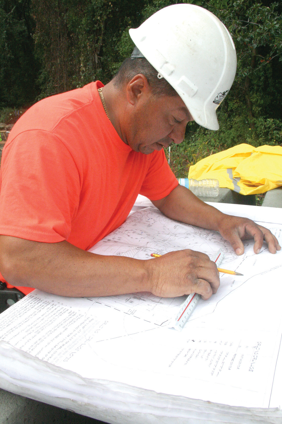 ALL THE DETAILS: Jesus Ortiz goes over plans in preparation to positioning the 12 circles featured in the park.