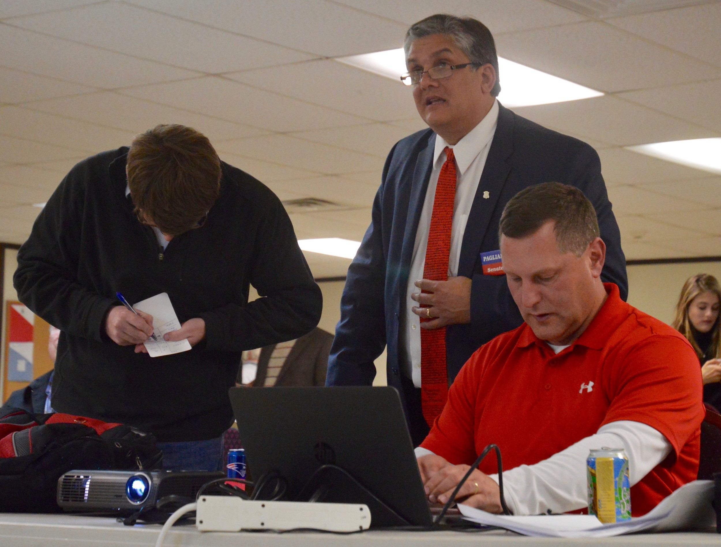 Sen. John Pagliarini Jr. (center) watches the numbers come in at the Republicans’ election night headquarters at St. John's Masonic Lodge Nov. 8. He’s flanked by Rep. Daniel P. Reilly (left), who didn’t run for re-election, and Town Council President Keith Hamilton, who retained his seat. Mr. Pagliarini lost to James Seveney in the District 11 Senate race.