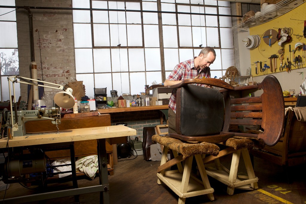 Drew Wheelan reviving an old chair in his studio
￼