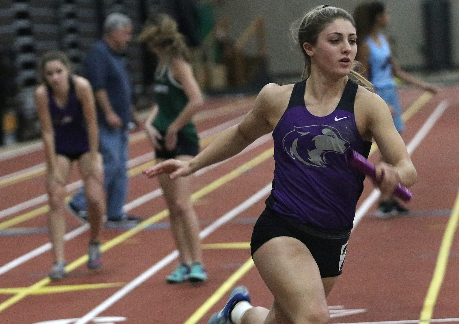 Meghan Oliver takes the baton from Leah Womelsdorf during the 4x200 meter relay.