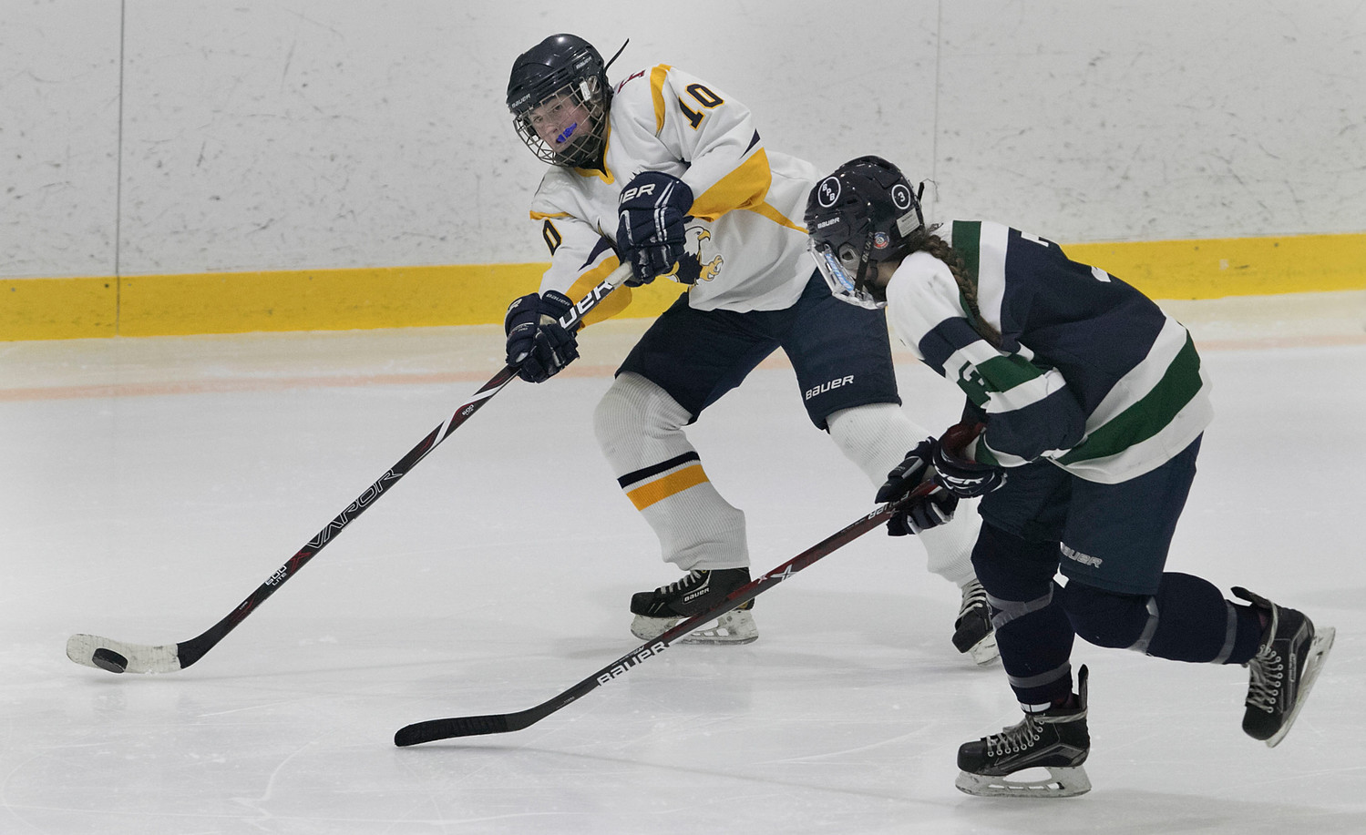 East Bay defenseman Madelyn Cox skates the puck into the offensive zone. She scored a goal and assisted on another during the game.