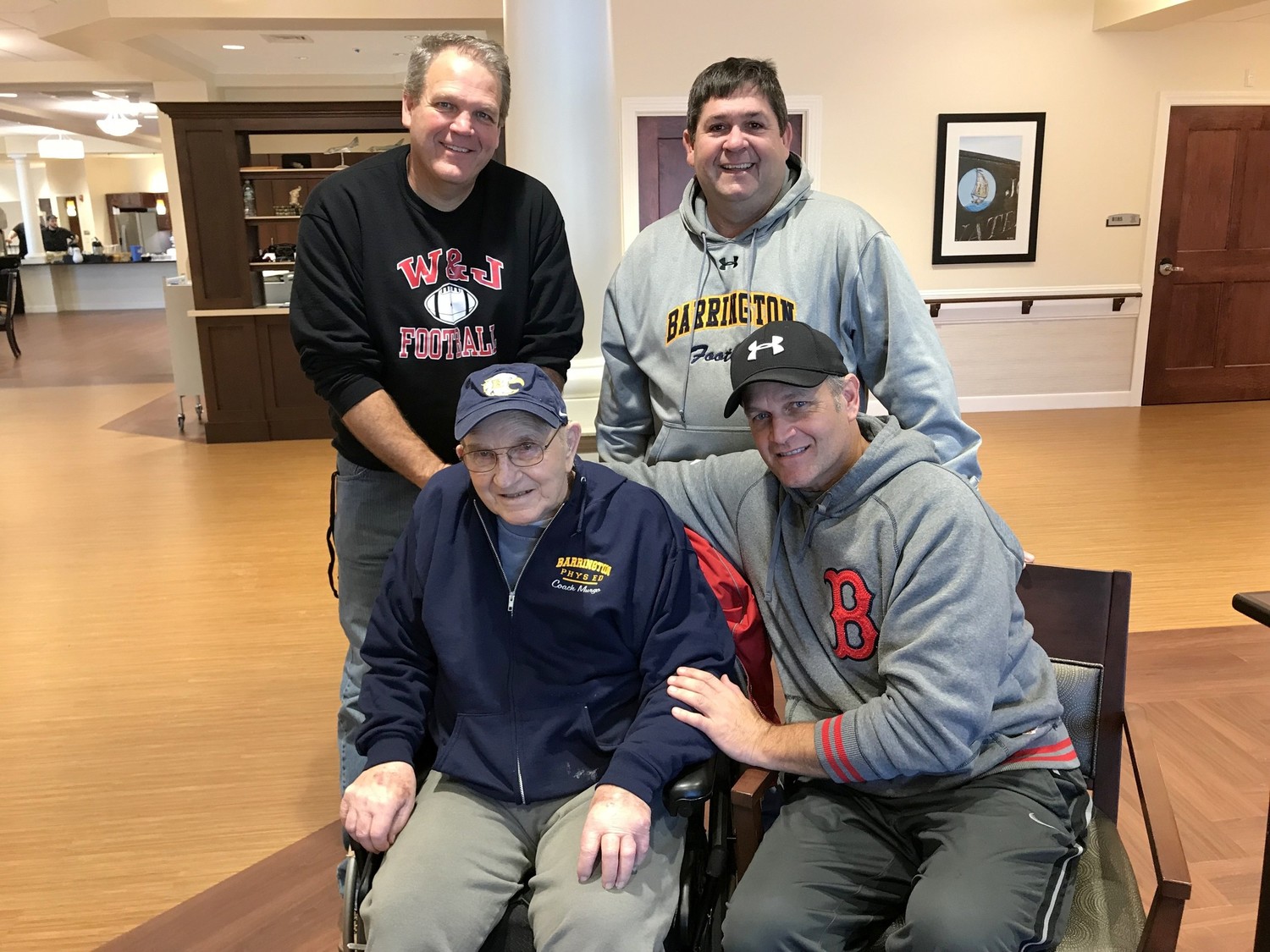 Coach Frank Murgo (seated left) is surrounded by (from left to right clockwise) Bruce Murgo, TR Rimoshytus, and Matt Murgo.