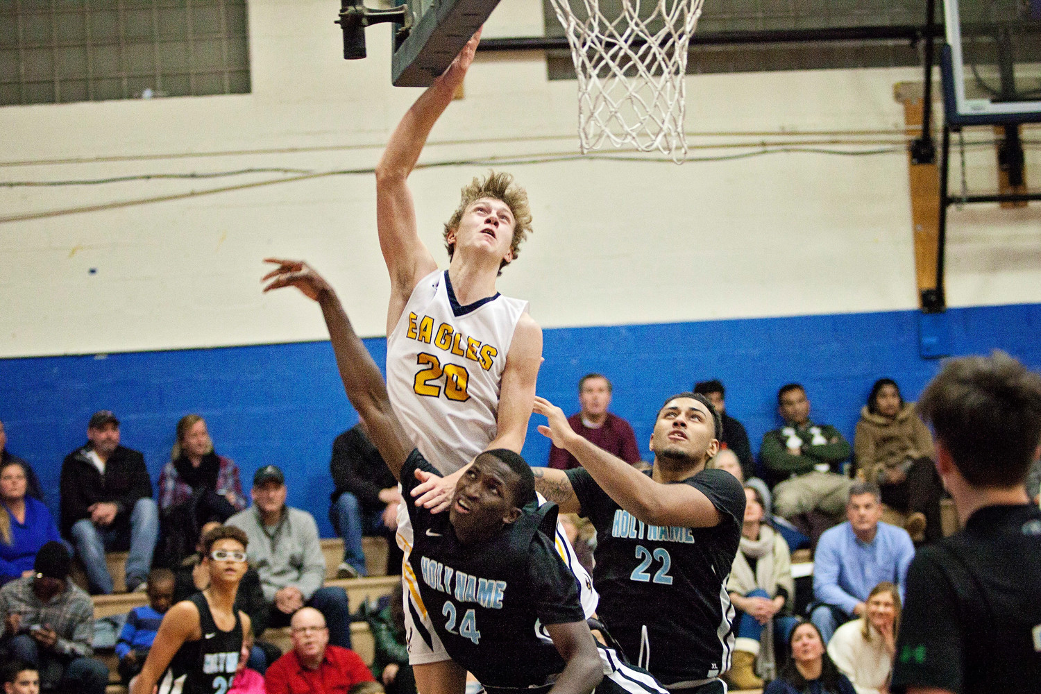 Deven Connors elevates over a pair of Holy Name defenders during the Eagles' 70-55 win over Wednesday night.