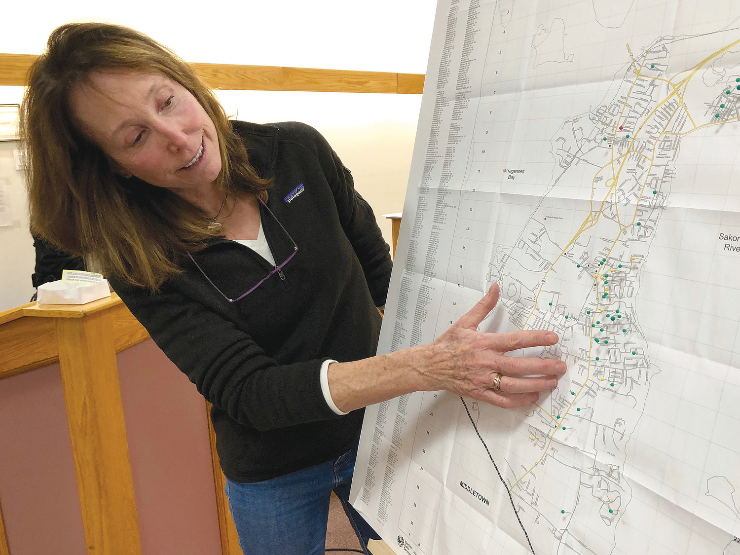 Numi Mitchell, lead scientist of the Narragansett Bay Coyote Study, points to an area on a Portsmouth map where the highest concentration of coyote sightings were reported to police over the past year.