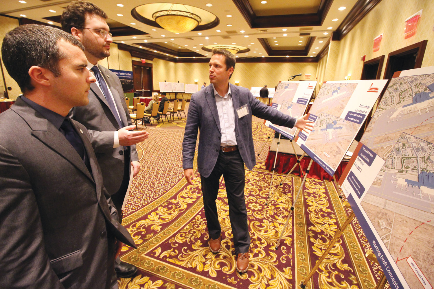 A BIGGER TERMINAL? Scott Tumolo of C&S reviews possible plans for the expansion of the Sundlun Terminal with Warwick City Council members Anthony Sinapi of Ward 8 and Jeremy Rix of Ward 2.