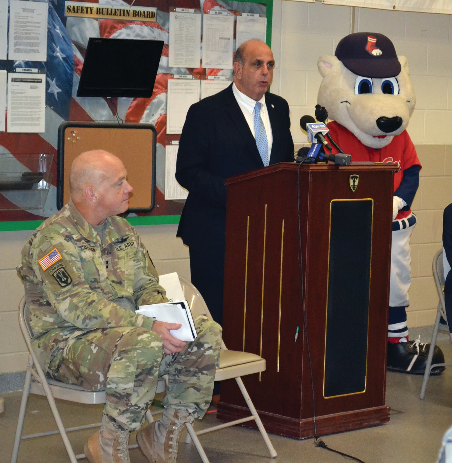 PROUD HOST: Warwick Mayor Joseph Solomon, pictured here between Maj. Gen. Christopher Callahan and Pawtucket Red Sox mascot Paws, spoke proudly of the city’s role in Operation Holiday Cheer.